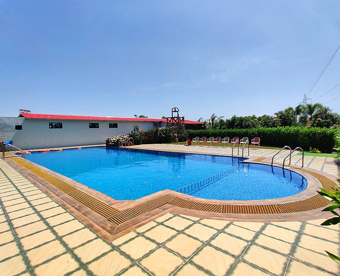 The luxurious swimming pool at The Destiny Resort, offering guests a relaxing and scenic environment in Sasan Gir