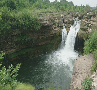 Jamjir Waterfall, a stunning natural attraction near Sasan Gir, offering picturesque views and a serene environment for visitors looking to explore the beauty of nature
